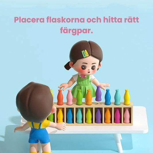 Barn spelar Drink Matching Game och placerar färgade flaskor i spelbrädan för att hitta rätt par.