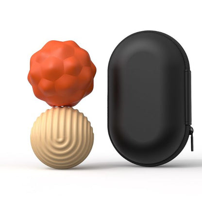 Beige och orangea magnetiska fidgetbollar i storlek Large bredvid svart förvaringsfodral.