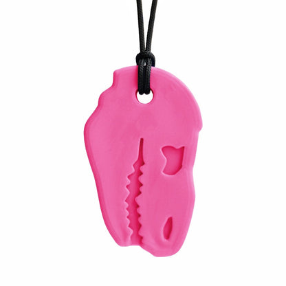 Tugghalsband Dino Bite i rosa färg, lekfull form för trygg sensorisk stimulans.